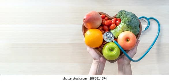 Fresh fruits and vegetables in a heart-shaped bowl for detox diet